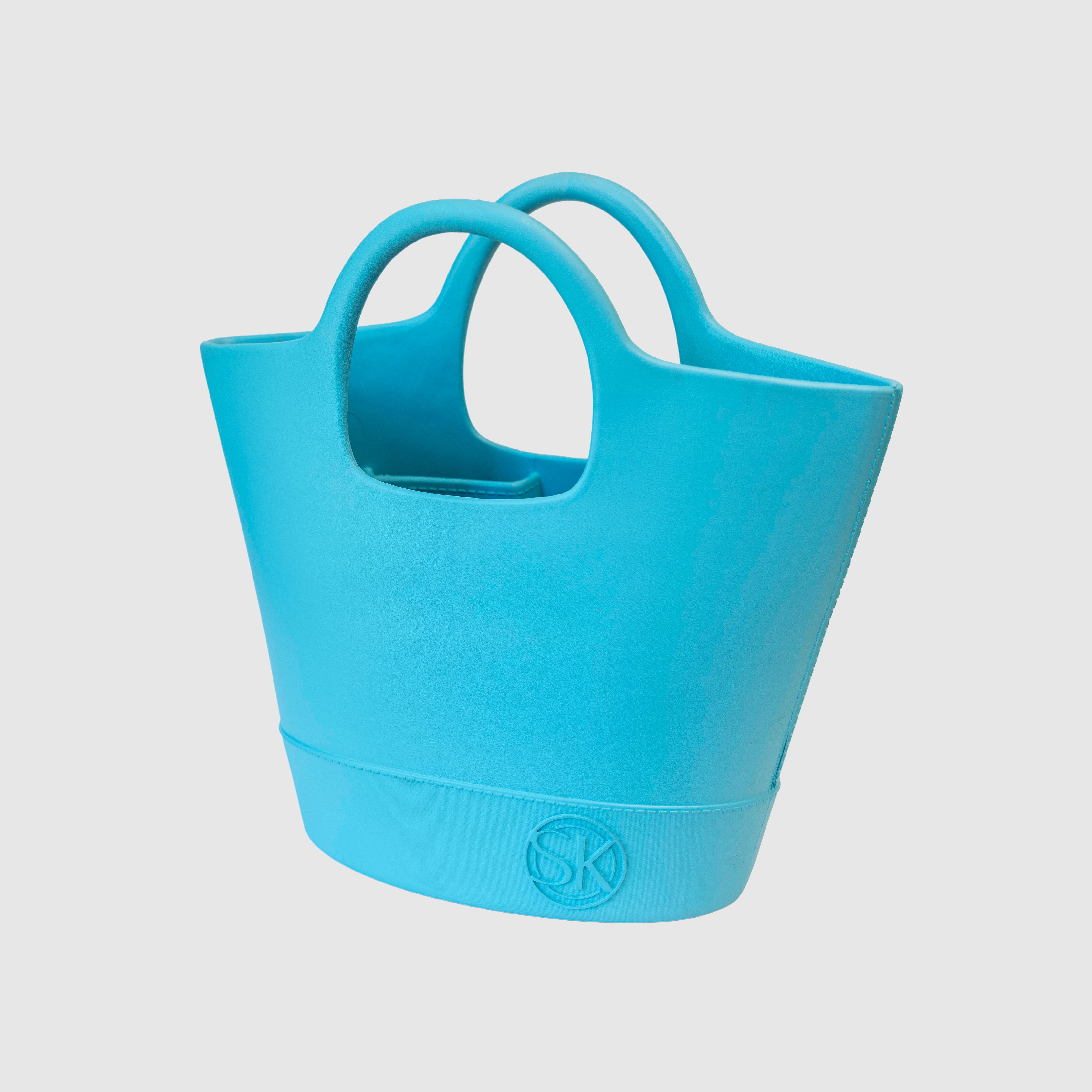 Angled view of blue Kennedy tote featuring SK logo embellishment on bottom right corner.