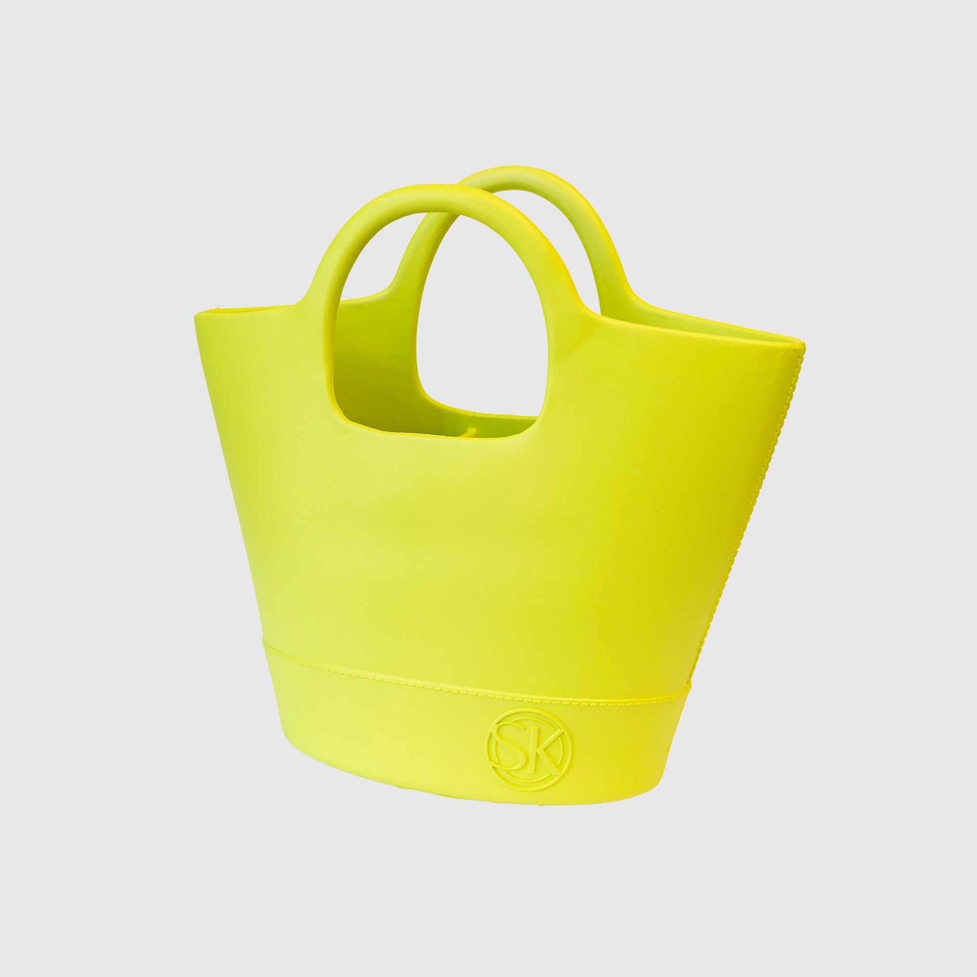 Angled view of lime colored Kennedy tote featuring SK logo embellishment on bottom right corner.